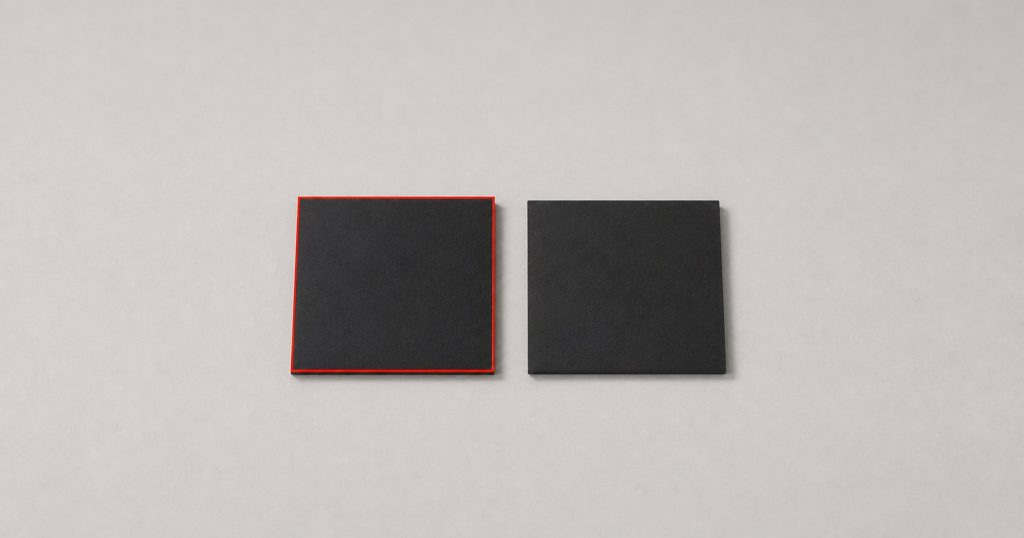 Two black squares side by side, one outlined in red and one with no outline, the second almost disappearing into the surface.