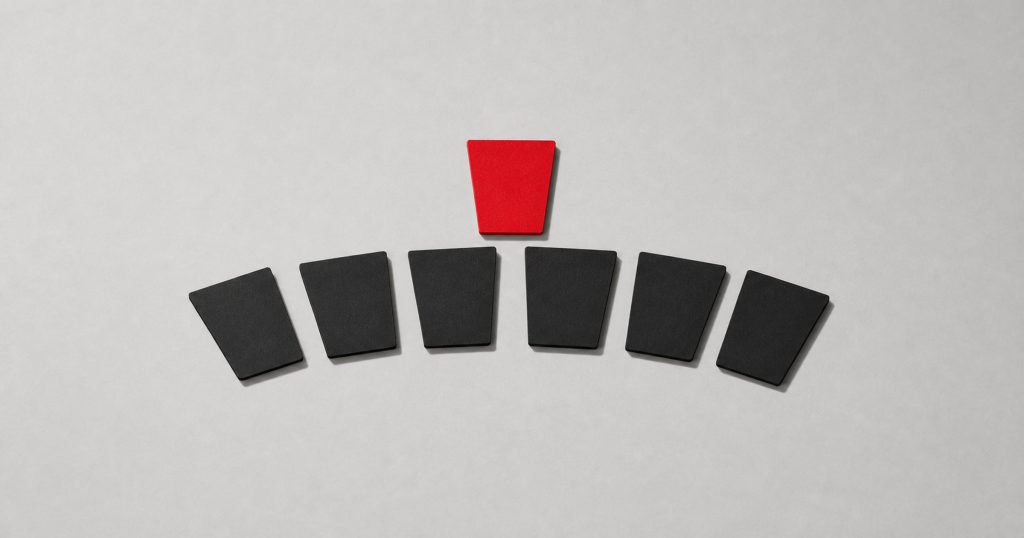 Six identical black cards fanned in an arc beneath a single red card.